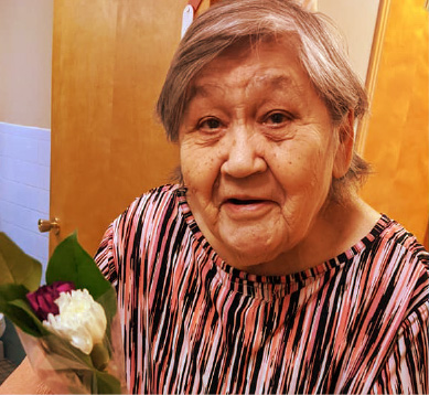 Friendly Face of Elder Woman with Flower